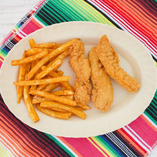 Nunez Foods chicken tenders and fries on a plate, set on a colorful striped Mexican blanket.